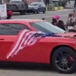 Anti-ICE protester waving upside-down US flag hit by car in New Jersey, video shows her being thrown to the ground