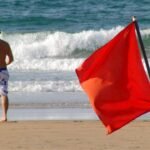 Beach Flag Rules: What do red, yellow, purple, green, and double flags mean at the beach? Why every traveller should be aware of these beach rules |