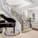 A gold-domed New York City penthouse first listed for $25 million has sold for $9 million after 530 days on the market, with owner Greg Carr directing the sale proceeds to his conservation project