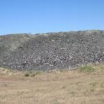 In 2002, Idaho buried nearly 300 tons of crushed waste glass beneath Highway 75; the material formed 8 to 12 inches of fill under a 200-foot road section