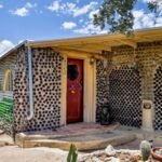 In 1964, an Arizona couple began building a carport with discarded bottles; years later, the project had grown into a 2,700-sq-ft home made with thousands of bottles and listed for $432,500
