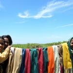 A Chinese village collected plastic from its mangroves and turned the waste into silk-like scarves for volunteers, linking cleanup with recycling