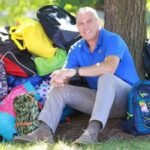 In 2013, Rob Scheer began packing backpacks at his dining table after recalling carrying his belongings in trash bags as a foster child; his charity has distributed 300,000+ backpacks