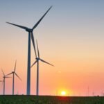 An Oregon wheat-farming couple had 13 wind turbines placed on their land; while crops continued around them, they said the operating turbines were bringing in about $100,000 a year