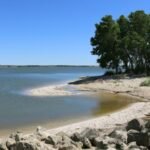 A Kansas couple wanted a beach without leaving home, so they turned two acres of their Olathe backyard into a 100,000-gallon lagoon with six waterfalls, tropical fish and a 23,000-pound boulder