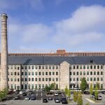 In 1848, a Massachusetts stone mill began making equipment for textile factories; after standing vacant, the 150,000-sq-ft landmark was restored for $53 million and converted into 86 apartments, 69 of them affordable