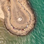 A cyclone wiped out Dhanushkodi in 1964 destroying its railway line and homes; six decades later, visitors travel to the ghost town to see abandoned ruins where the Bay of Bengal meets the Indian Ocean