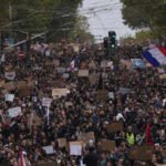 France pledges education reforms after protests over costs, school funding