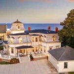 Iconic 1880s Rhode Island waterfront social club is being offered for the first time in 50 years; after a $1.2 million price cut, the historic five-bedroom property now asks $9.75 million