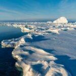 Arctic ice had been expanding for at least 1,000 years before reaching its greatest extent around 1960; researchers say greenhouse warming then reversed a natural slide toward another ice age