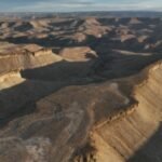 Utah approved blasting 100-foot canyon cliffs to widen a 5.3-mile road for oil trucks; after two earlier plans failed, a new federal lawsuit says 47 historic sites and 19th-century inscriptions are at risk