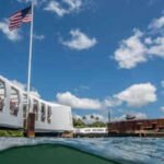 In 1961, Elvis Presley raised $65,000 toward the USS Arizona Memorial; a year later, the 184-foot structure opened above the Pearl Harbor wreck, where more than 900 crewmen remain entombed and oil still leaks
