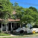 A Connecticut town paid $455,000 for a historic two-family home to create about 20 library parking spaces; a state preservation council has now voted to ask the attorney general to stop its demolition