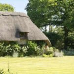 In 2008, Sienna Miller bought a 16th-century thatched cottage and later replaced its gravel driveway with a wildflower meadow; now, the half-acre retreat is on sale for £1.75 million
